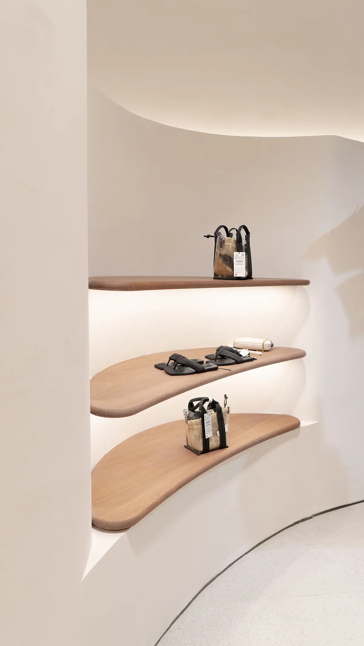 Display niche with wooden shelves set into a curved wall