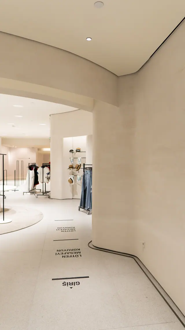 Curved wall in front of fitting rooms