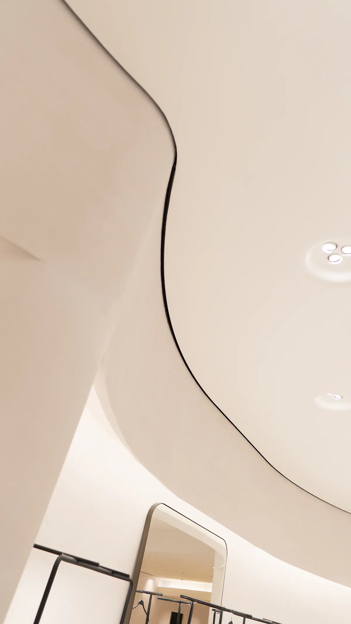 Curved wall and ceiling transition built with BendBoard in a retail interior
